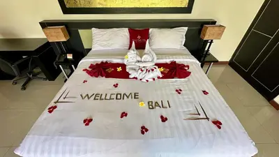 a bed with a white bedspread with flowers on it at 1 Bed Room Private Pool Villa in Seminyak - PBM1 in Seminyak