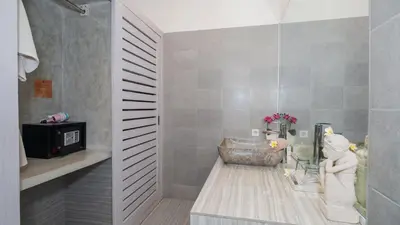 a bathroom with a sink and a bath tub at Villa Larimar by Villa Finder in Legian