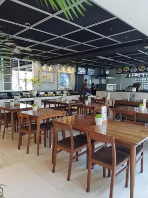 a dining room with wooden tables and chairs at Cozy Apartement in Seminyak in Uluwatu