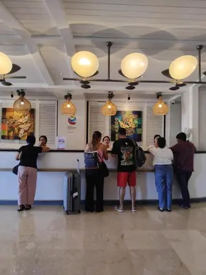 a group of people waiting at a counter at an airport at Cozy Apartement in Seminyak in Uluwatu
