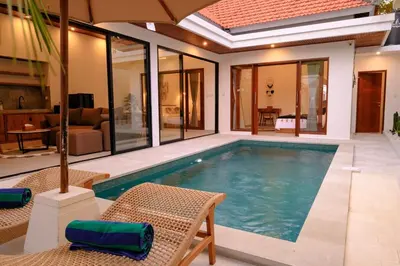 a swimming pool in the middle of a house at New Vindra II Villa Mediteranian 2BR Canggu in Canggu