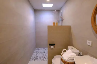 a bathroom with a sink and a toilet and a mirror at New Vindra II Villa Mediteranian 2BR Canggu in Canggu