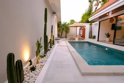 a swimming pool in a house with cactus at New Vindra II Villa Mediteranian 2BR Canggu in Canggu