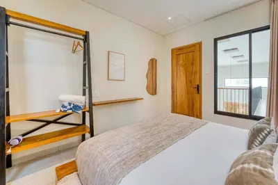 a bedroom with a bed and a window at Casa Amadeo Villas Seminyak in Seminyak