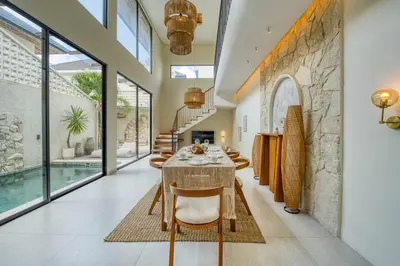 a dining room with a table and chairs at Casa Amadeo Villas Seminyak in Seminyak