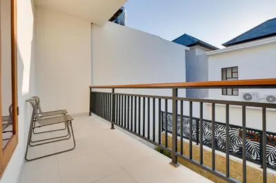 a balcony with a bench and a railing at Stylish 2BR Villa Taman Seminyak 52 near Beach in Seminyak
