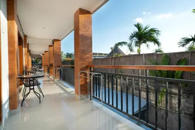 a balcony with a table and chairs on it at Narmada House Seminyak in Seminyak