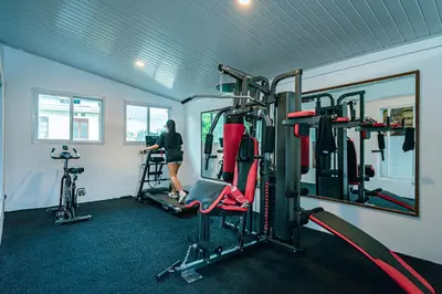 a woman in a gym with two tread machines at Amshiga 1 in Jimbaran