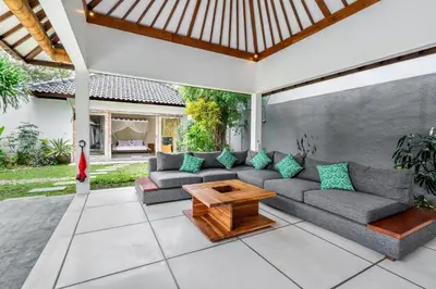 a patio with a couch and a table at Balima Villa in Seminyak