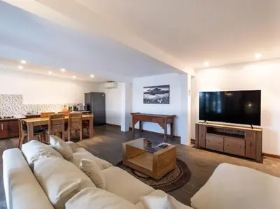 a living room with a white couch and a flat screen tv at Villa Melissa in Kerobokan