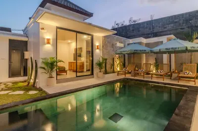 a swimming pool in front of a house at Villa Vela 1 - Brand new 3 bedroom villa in Seminyak