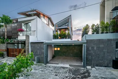 an image of a house with a garage at Divija Villa by Unicorn Villas Bali in Kerobokan