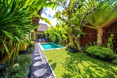a backyard with a swimming pool and some plants at Villa ABBI Luxury 2 Bedroom Villa - Legian Seminyak in Seminyak