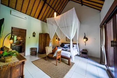 a bedroom with a bed with a canopy at Villa ABBI Luxury 2 Bedroom Villa - Legian Seminyak in Seminyak