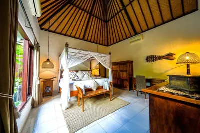 a bedroom with a bed with a canopy at Villa ABBI Luxury 2 Bedroom Villa - Legian Seminyak in Seminyak