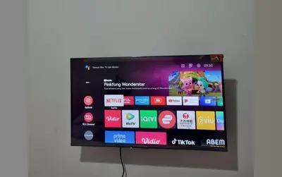 a flat screen tv hanging on a wall at RBE Hotel Kuta 2- 5 Min to Airport&Beach by Micky Studio in Ngurah Rai International Airport