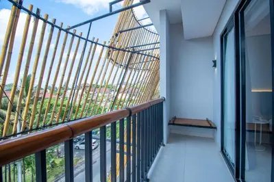 a balcony with a view of the city at Koa D Surfer Hotel in Canggu