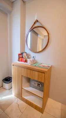 a bathroom with a vanity with a mirror on the wall at Koa D Surfer Hotel in Canggu