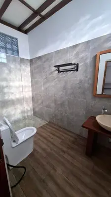 a bathroom with a sink and a tub and a toilet at Villa Loba Sanur in Sanur