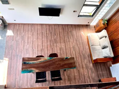 a living room with a table and a tv at Villa Loba Sanur in Sanur