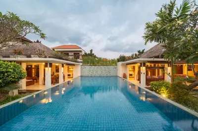 a swimming pool in front of a villa at The Cemara Umalas in Kerobokan