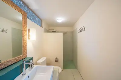 a bathroom with a sink and a toilet and a mirror at The Cemara Umalas in Kerobokan