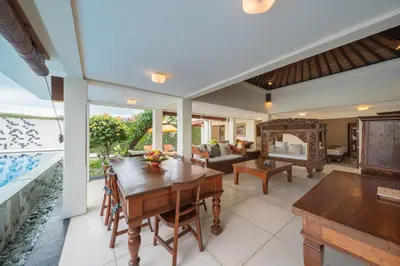 a dining room with a table and a couch at The Cemara Umalas in Kerobokan
