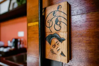 a wooden door with a picture of a woman on it at Abia Villa Legian in Legian