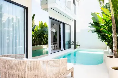 a swimming pool in the middle of a house at Villa Amare in Kerobokan