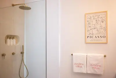 a bathroom with a shower and a towel at Villa Amare in Kerobokan