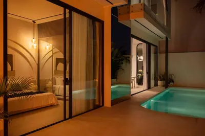 a house with a swimming pool and a bedroom at Villa Amare in Kerobokan