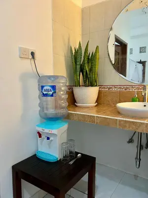 a bathroom with a blender on a table next to a sink at Will and Ray's at Lori Beach Inn in Seminyak