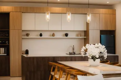 a kitchen with a table with a vase of flowers at Villa Toku by BaliSuperHost in Seminyak