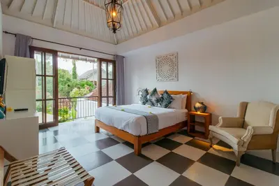a bedroom with a bed and a chair at Private 2 Br Pool Villa, 400m to Beach, Sleeps 4 in Seminyak