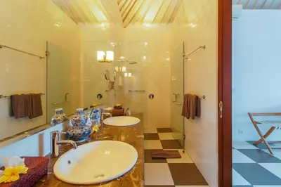a bathroom with two sinks and a shower at Private 2 Br Pool Villa, 400m to Beach, Sleeps 4 in Seminyak