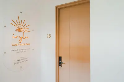 a door to a room with a sign on the wall at Iryla Villa Bali in Seminyak
