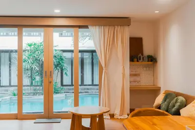 a living room with a couch and a table at Iryla Villa Bali in Seminyak