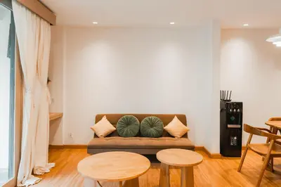 a living room with a couch and two tables at Iryla Villa Bali in Seminyak
