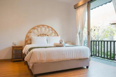 a bedroom with a bed with a teddy bear on it at Iryla Villa Bali in Seminyak