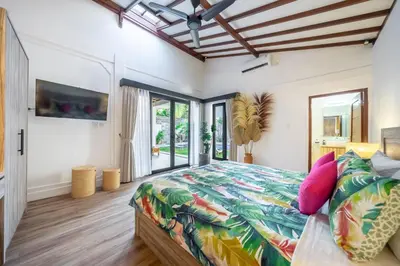 a bedroom with a large bed with a colorful bedspread at Villa Lebah Seminyak in Seminyak