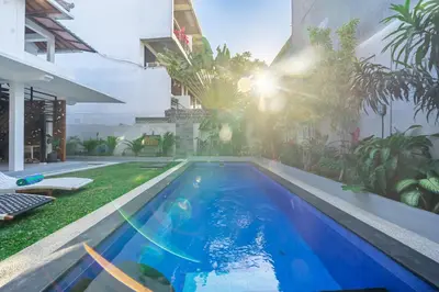 a swimming pool in the yard of a building at Villa Lebah Seminyak in Seminyak