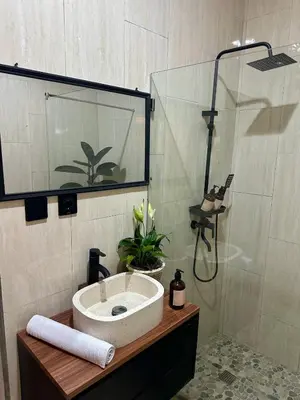 a bathroom with a sink and a shower at Villa Vela 6 BR Seminyak in Seminyak