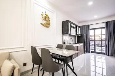 a kitchen with a table and chairs in a room at Aurelia Home at Mogan Residence in Seminyak