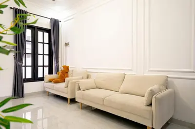 a living room with a couch and a teddy bear at Aurelia Home at Mogan Residence in Seminyak