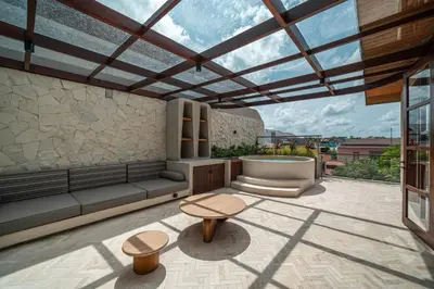 a patio with a tub and a table and benches at Sonaa Villa Bali in Canggu