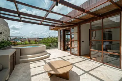 a patio with a table and a pool at Sonaa Villa Bali in Canggu