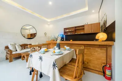 a kitchen and dining room with a table and chairs at Adikara Villa 2 Cozy 2BR in Canggu, Berawa 5 mins to the beach in Canggu