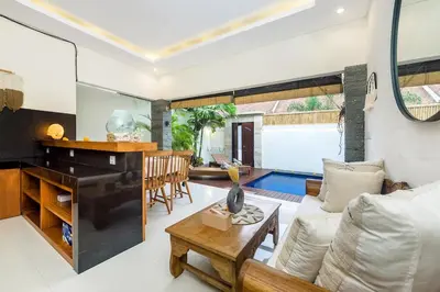 a living room with a couch and a piano at Adikara Villa 2 Cozy 2BR in Canggu, Berawa 5 mins to the beach in Canggu