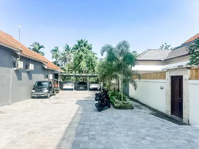 a motorcycle parked in a parking lot next to a house at Adikara Villa 2 Cozy 2BR in Canggu, Berawa 5 mins to the beach in Canggu