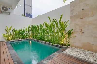 a swimming pool in the side of a building at Stylish 3BR Villa Palm Haven 11 near Central Seminyak in Seminyak
